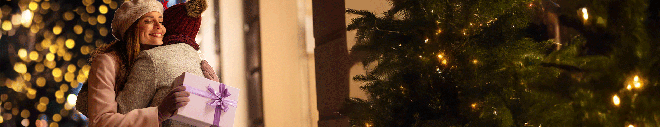 Hugging with gift during the holidays.