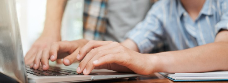 A student typing on a laptop