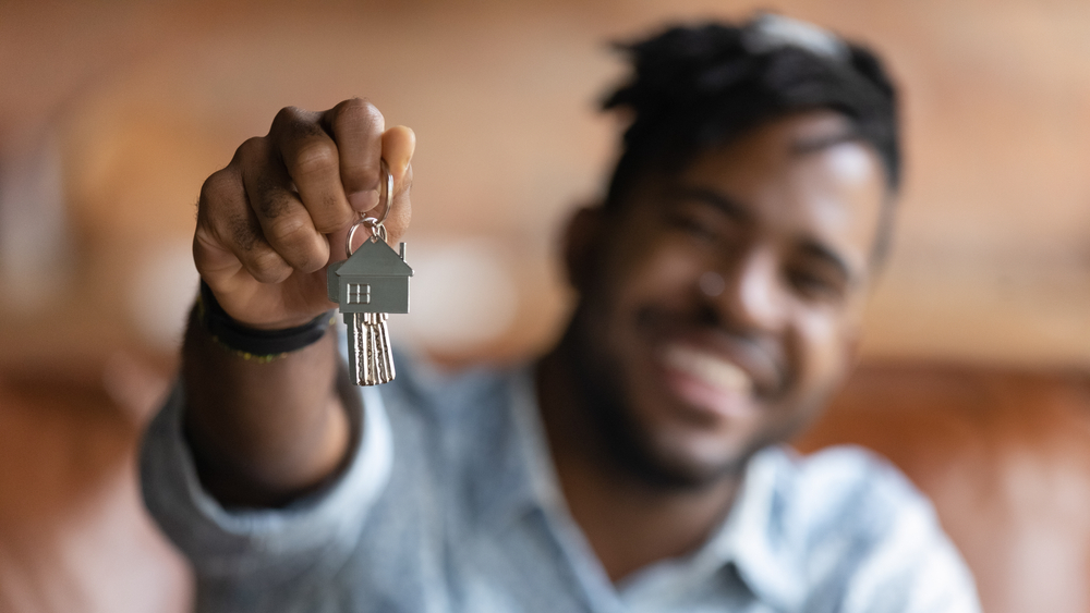 Man holding up house keys.