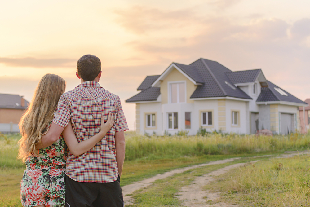 Young couple looking at newly built home.