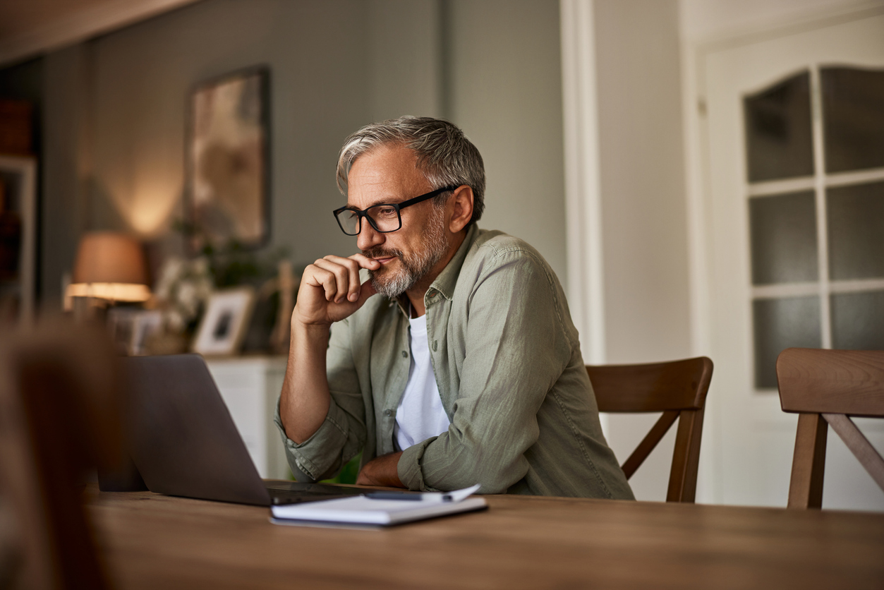 A man on his laptop reading a press release