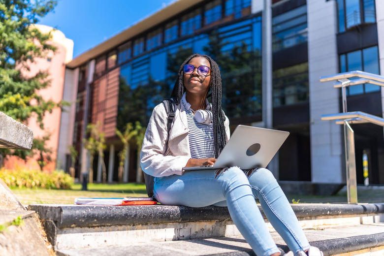 A student on campus with her laptop