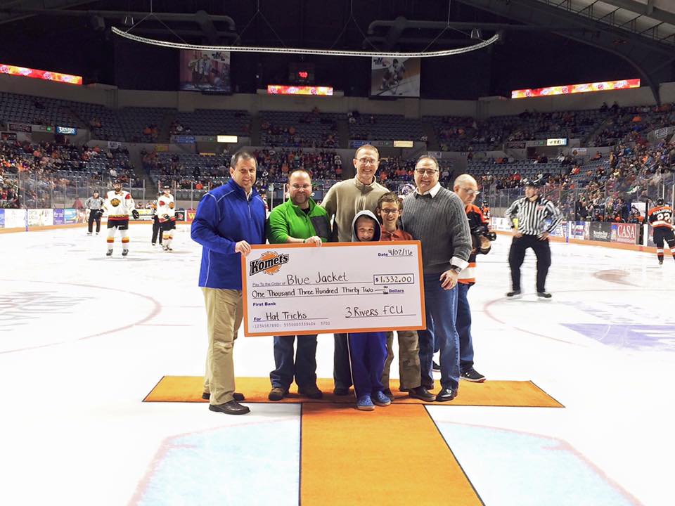 3Rivers CEO, Don Cates, presents Blue Jacket, Inc. with a check during a Komets game, April 2016.