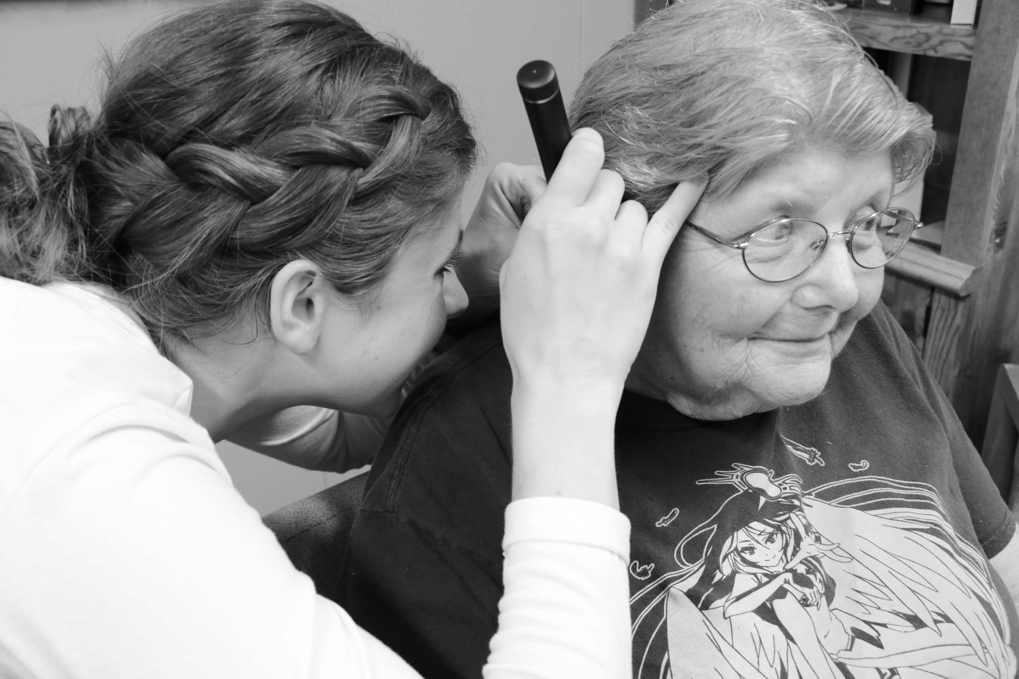 A doctor examining a patient's ear.