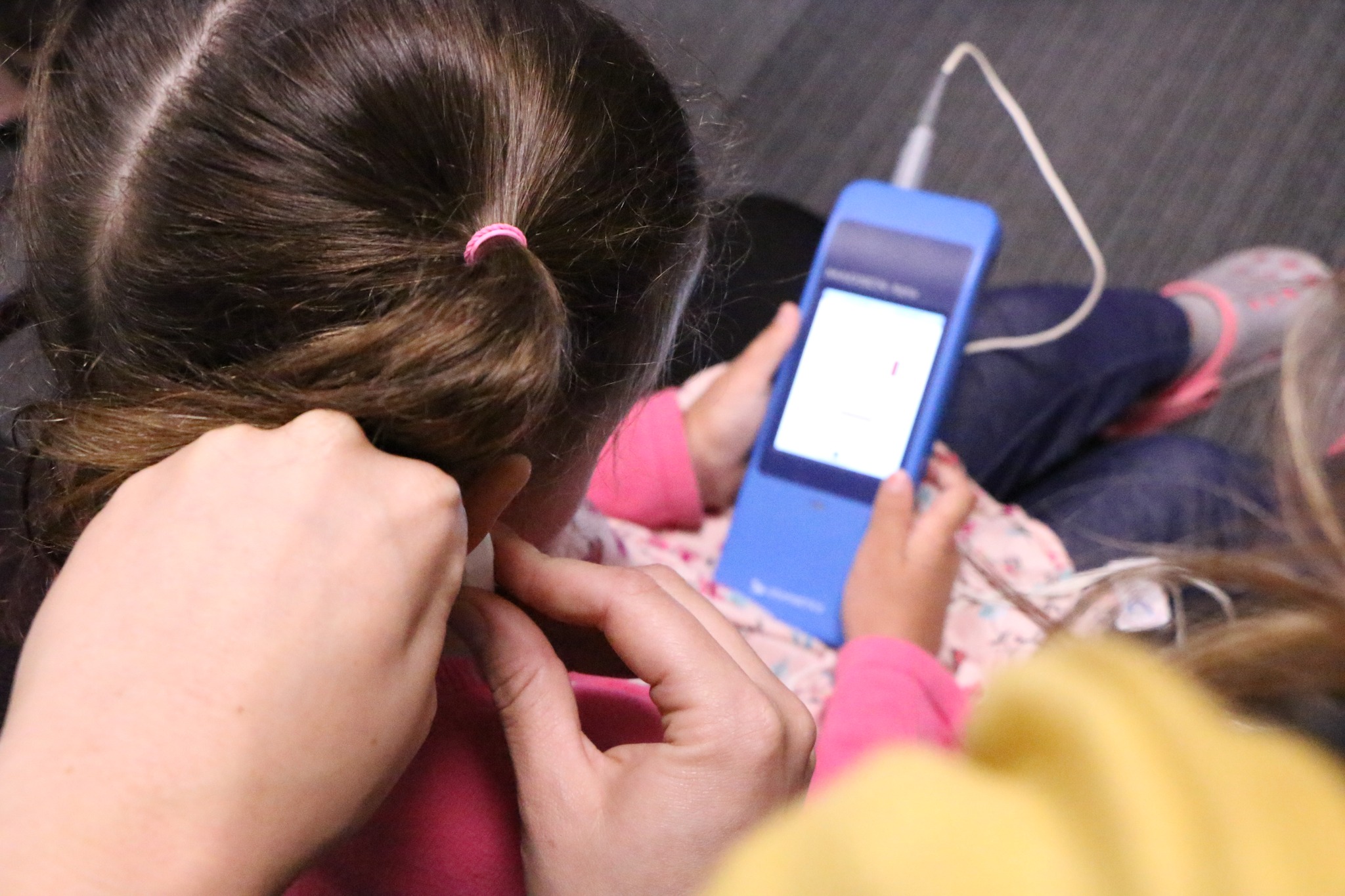 GiveHear testing a child's hearing.