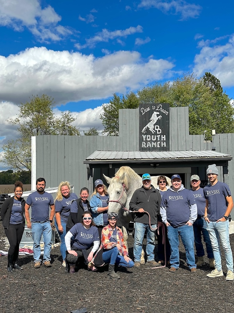 A group of 3Rivers employees pose for a photo at Dare to Dream Youth Ranch during their 2023 Give Back Day.