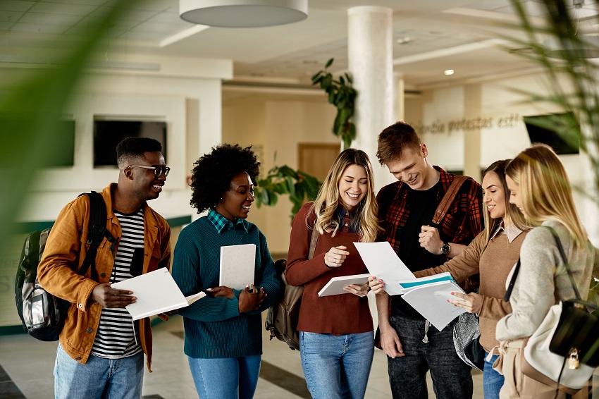 Students standing in room at college.