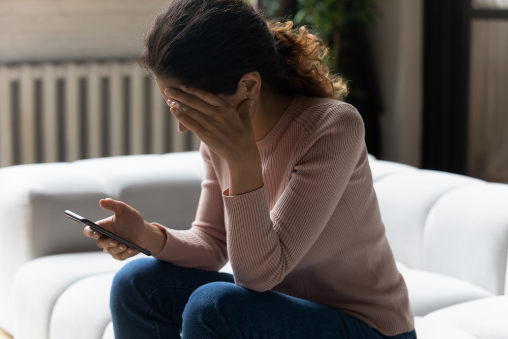 Stressed young woman on phone.