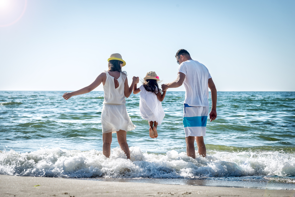 Family playing in ocean.