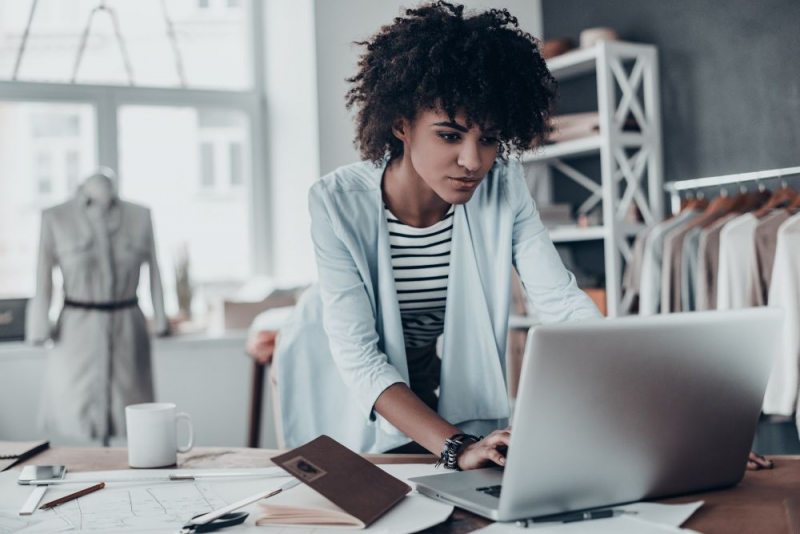 Woman on laptop computer at her small business.